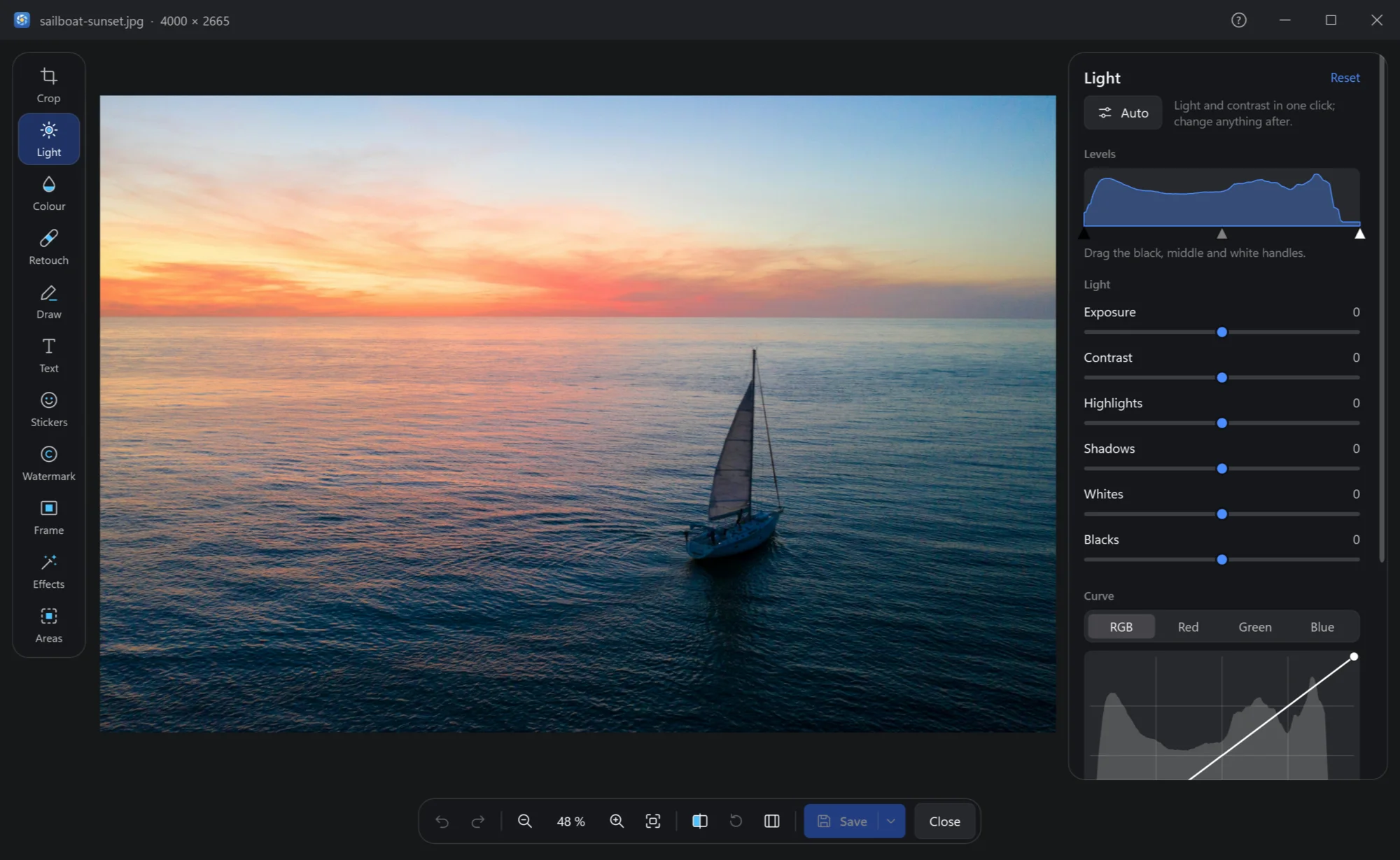 The editor with a sailboat at sunset, the tools on the left and the Light panel on the right